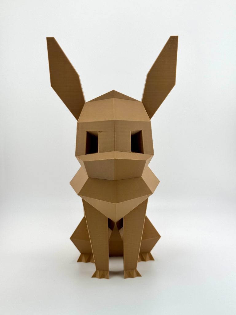 Rich brown low-poly 3D-printed Eevee coin bank, standing 23.5 cm tall with a distinct, angular design and a coin slot and removable cap at the bottom, perfect for Pokémon fans.