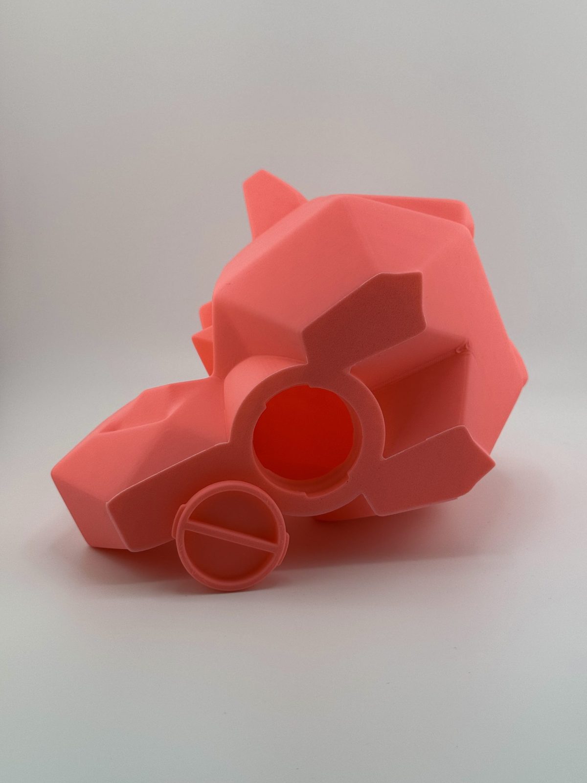 Bright pink low-poly 3D-printed Clefairy coin bank, standing 18 cm tall with a coin slot, capturing the enchanting essence of the beloved Pokémon.