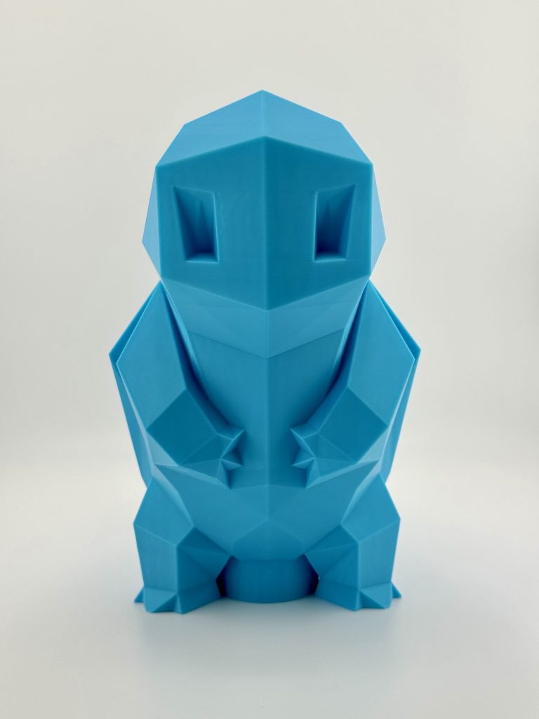 Light blue low-poly 3D-printed Squirtle coin bank, standing 19.5 cm tall with a coin slot, inspired by the classic water-type Pokémon.