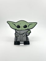 Compact foldable phone stand featuring a multi-color Yoda design, inspired by Star Wars, perfect for supporting smartphones and small tablets.