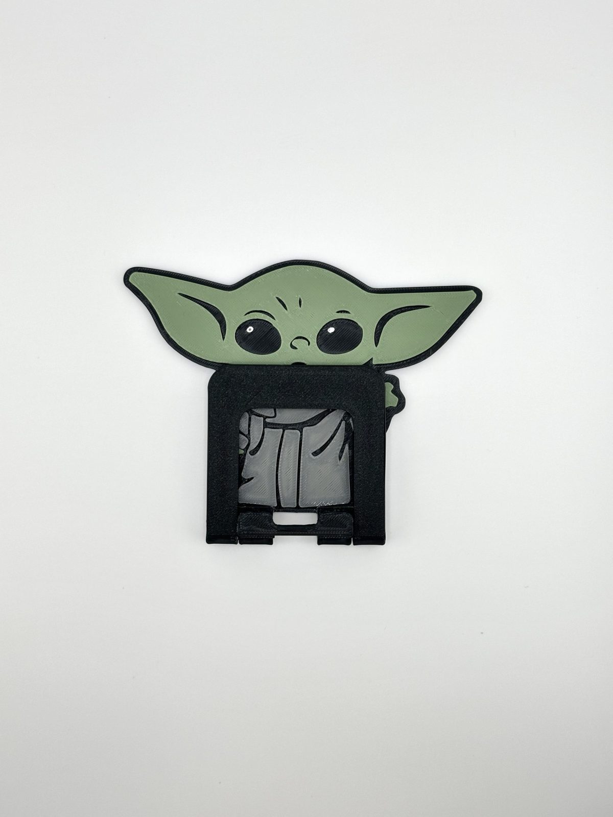 Compact foldable phone stand featuring a multi-color Yoda design, inspired by Star Wars, perfect for supporting smartphones and small tablets.