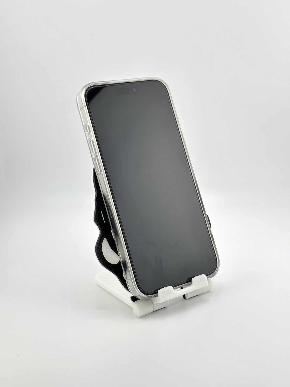 Compact foldable phone stand with a black and white Stormtrooper design, inspired by Star Wars, ideal for supporting smartphones and small tablets.