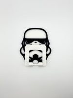 Compact foldable phone stand with a black and white Stormtrooper design, inspired by Star Wars, ideal for supporting smartphones and small tablets.