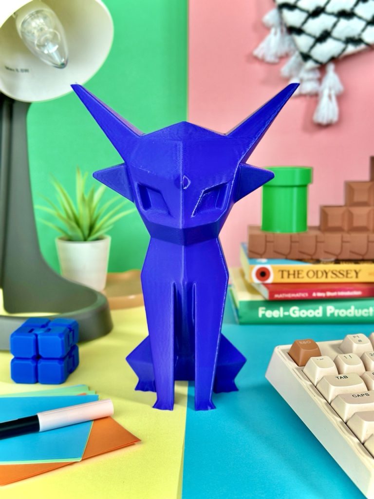 Vibrant purple low-poly 3D-printed Espeon coin bank, standing 22 cm tall, equipped with a coin slot and a removable twist cap at the bottom, perfect for fans of the mystical Pokémon.