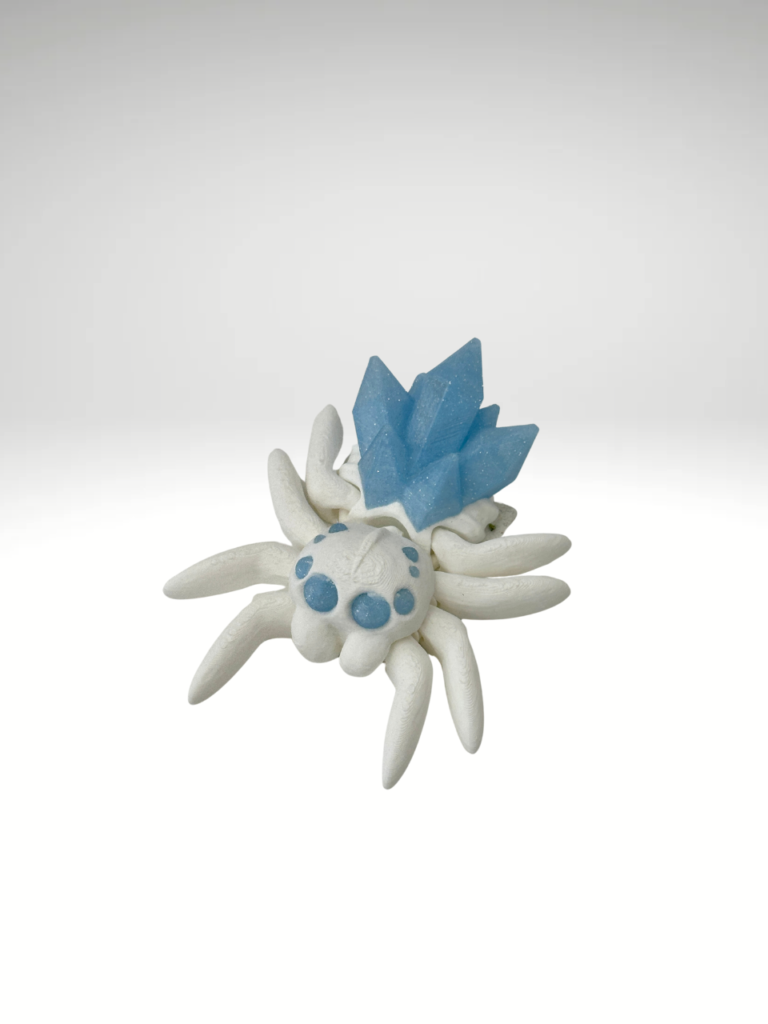 A-3D-printed-crystal-spider-figurine-in-blue-and-white-with-intricate-details-and-a-translucent-gem-like-appearance.